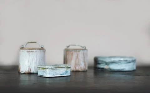 Small old boxes painted white on the wooden table Stock Photos