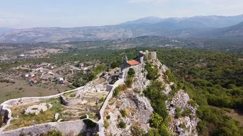 Small old chapel with stone wall on the top of the rock Stock Footage 167702884