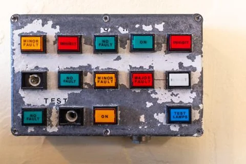 A small old control panel showing buttons of various colours on old paint pee Stock Photos