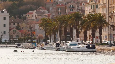 Small old harbour of "Matejuska" in Split, Croatia. Small boats docked, palms Stock Footage 128986611