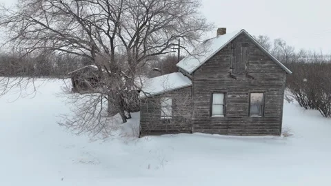 Small, old house sits in the snow Stock Footage 301362811