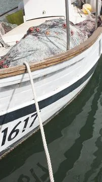 Small old ship moored in the harbor Stock Photos
