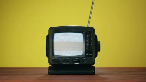 Small old television with grey interference screen on yellow background. Close Stock Footage 169115632