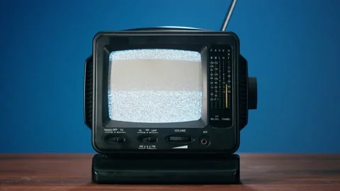 Small old television with grey interference screen on blue background. Close-up Stock-Footage 169115869