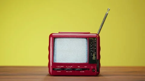 Small old television with grey interference screen on yellow background. Close Video stock 169309904