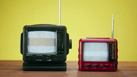 Small old televisions with grey interference screen on yellow background. Close Stock Footage 169310385