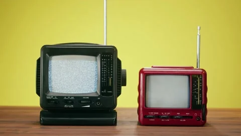 Small old televisions with grey interference screen on yellow background. Close Stock Footage 169733697