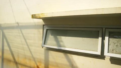 Small open window on modern exterior wall Stock Photos