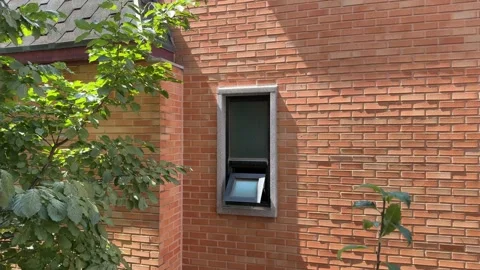 Small Open Window on Red Brick Wall with Swaying Green Branches Stock Footage 347301681