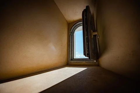 Small open window with sky and sun Stock Photos