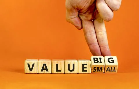 Small or big value symbol. Businessman turns wooden cubes and changes words ' Stock Photos