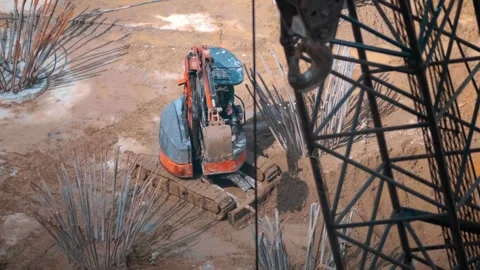 A small orange and gray compact mini excavator working in a dirt pit  Stock Footage 340629622