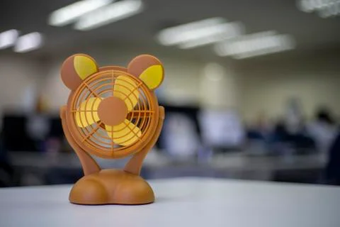Small orange fan on the table or toy Stock Photos