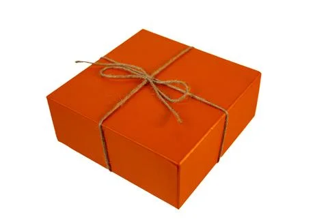Small orange present box tied with rustic brown rope bow on white Stock Photos