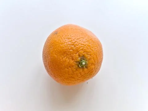 A small orange with a stem on top Stock Photos