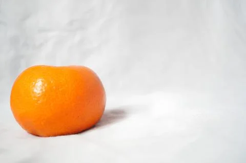 A small orange on a white background Stock Photos