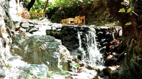Small outdoor cafe with a small waterfall Stock Footage 83503541