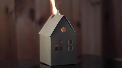 A small paper house completely burns down, a burning house, a fire Stock Footage 243280792