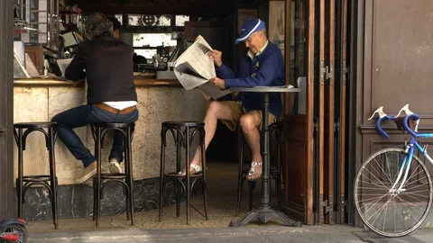 Small Paris Cafe Table Senior Man Read Newspaper Stock Footage 116709075