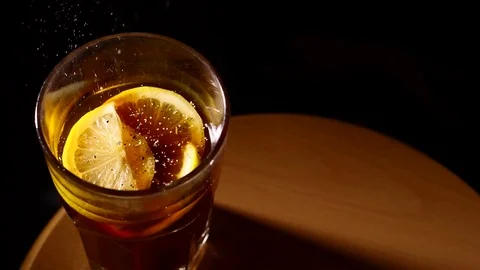 Small particles falling into glass of cocktail slowmo Stock Footage 84073900