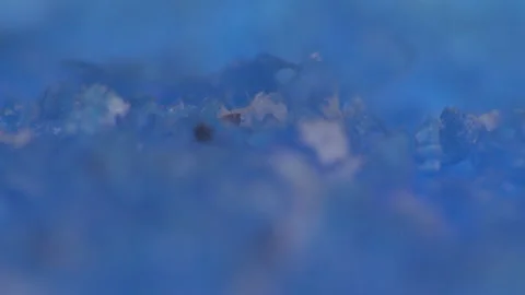 Small particles of plastic stick together in water Stockbeeldmateriaal 110799349