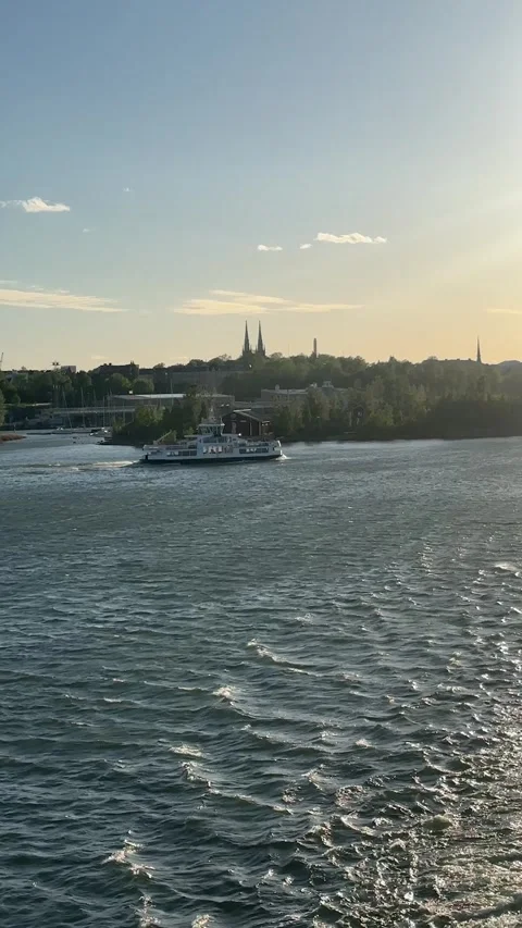 Small passenger boat sailing toward an island near Helsinki, Baltic Sea.mp4 Stock Footage 341839923