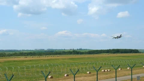 Small passenger plane aproaching for landing in the airport font lateral view Stock Footage 253708145