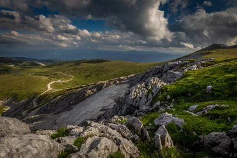 Small patch of snow in the summer in the middle of grassy meadow in rax plateau Stock Photos