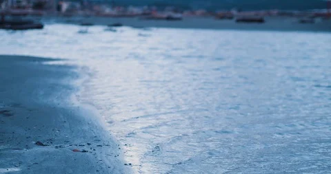 Small patch of water flows from the ocean onto the beach Stock Footage 101568189
