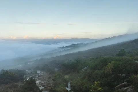 Small path of water runing down the rocks between the mist in a trail in Galicia 写真素材