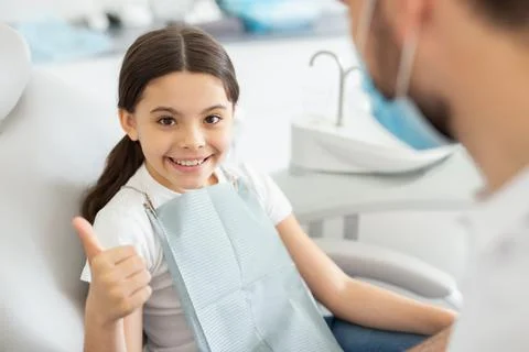 Small patient looking at the camera showing thumb up Stock Photos