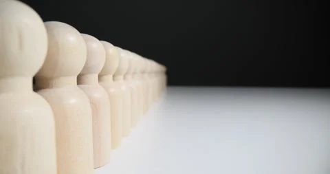 Small pawns line on white table in studio presenting queue Stock Footage 269117204