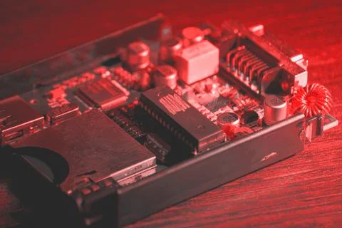 Small PCB and processor on the table in the pink neon lights Stock Photos