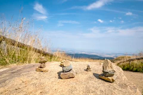 Small pebble stacks balancing on a large rock Stock Photos