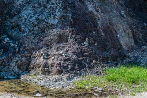 Small pebble stacks on granite wall Stock Photos
