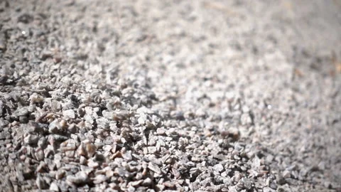 Small pebbles falling in a pile in slow motion Stock Footage 134337073