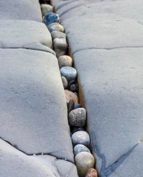 Small pebbles stuck in between larger rocks Stock Photos