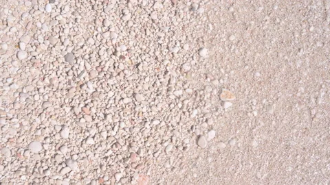 Small pebbles on a white beach and transparent waves. View from above Stock Footage 231509993
