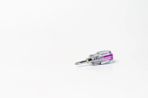 Small Phillips screwdriver with a transparent handle lying Stock Photos