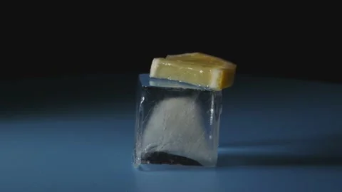 Small piece of lemon lies on an ice cube. Stock Footage 149207809