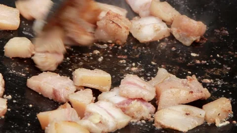 Small pieces of fat are fried in a large frying pan on coals Stock Footage 150046782