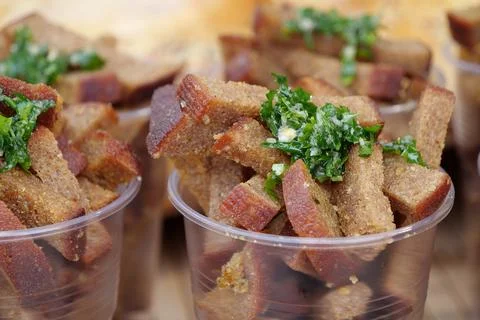 Small pieces of toasted bread in plastic glasses Photos