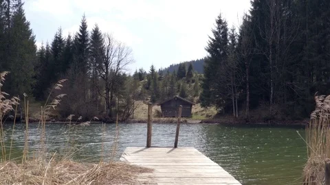 Small pier on the Lake with the house on the background Stock Footage 74661732