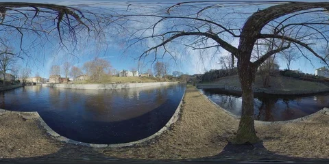Small Pier, Under Relaxing Tree and Flowing River Sunny Downtown - 360 VR Stock Footage 104576979