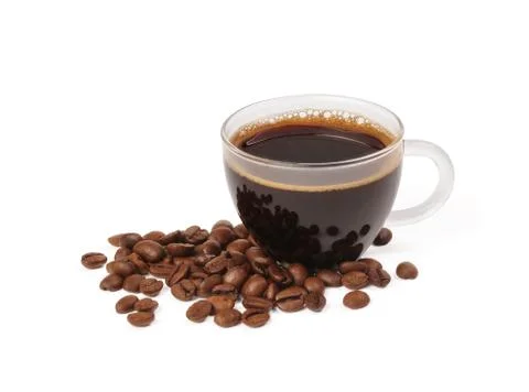 Small pile of coffee beans next to a freshly brewed cup of black coffee Stock Photos