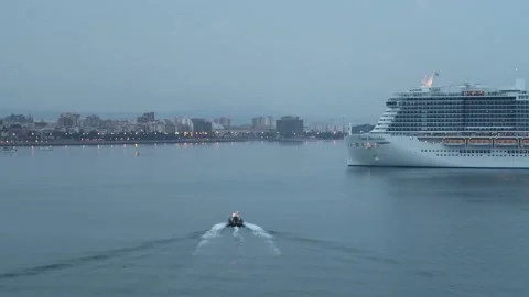 Small Pilot Boat heading towards large cruise ship, Palma, Spain Stock Footage 221928884