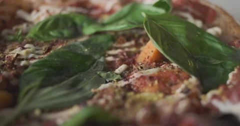 Small pizza with basil. Close-up, camera fly over pizza with selective focus. Vidéo 232212441