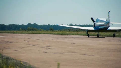 Small plane aircraft is moving on on the runway. Airfield of flying aero club  Stock Footage 101062809