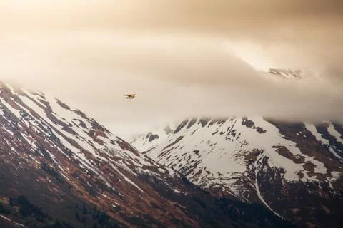 Small plane in big mountains Stock Photos