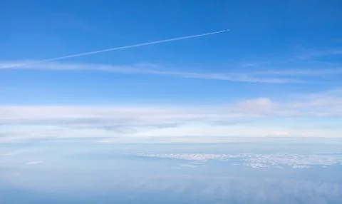 Small plane in the boundless sky above clouds Stock Photos